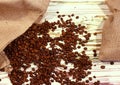 ÃÂ ÃÂ ÃâÃÂÃÂ¡offee beans in a bag on a light wooden background, top view. Shy pastel background. Natural food